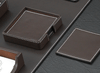 set of four brown leather coasters with contrasting stitching