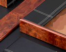 detail of burled wood and leather desk pad set